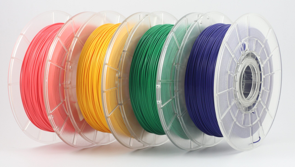 Multiple 3D printing filament spools in various colors representing a wide range of material options