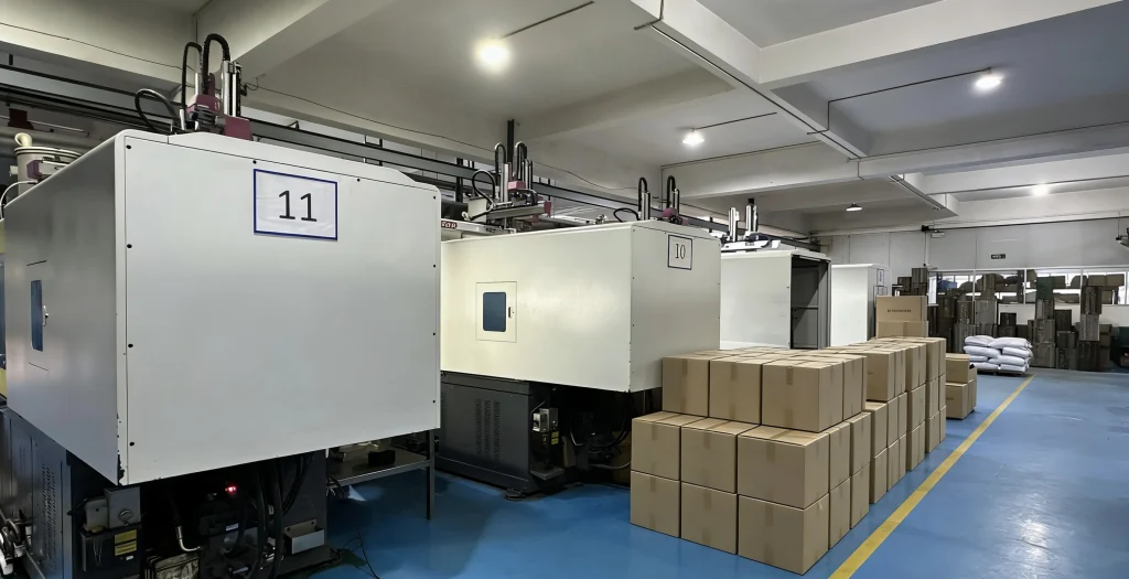 Injection molding factory production line with multiple machines and finished plastic parts ready for shipment