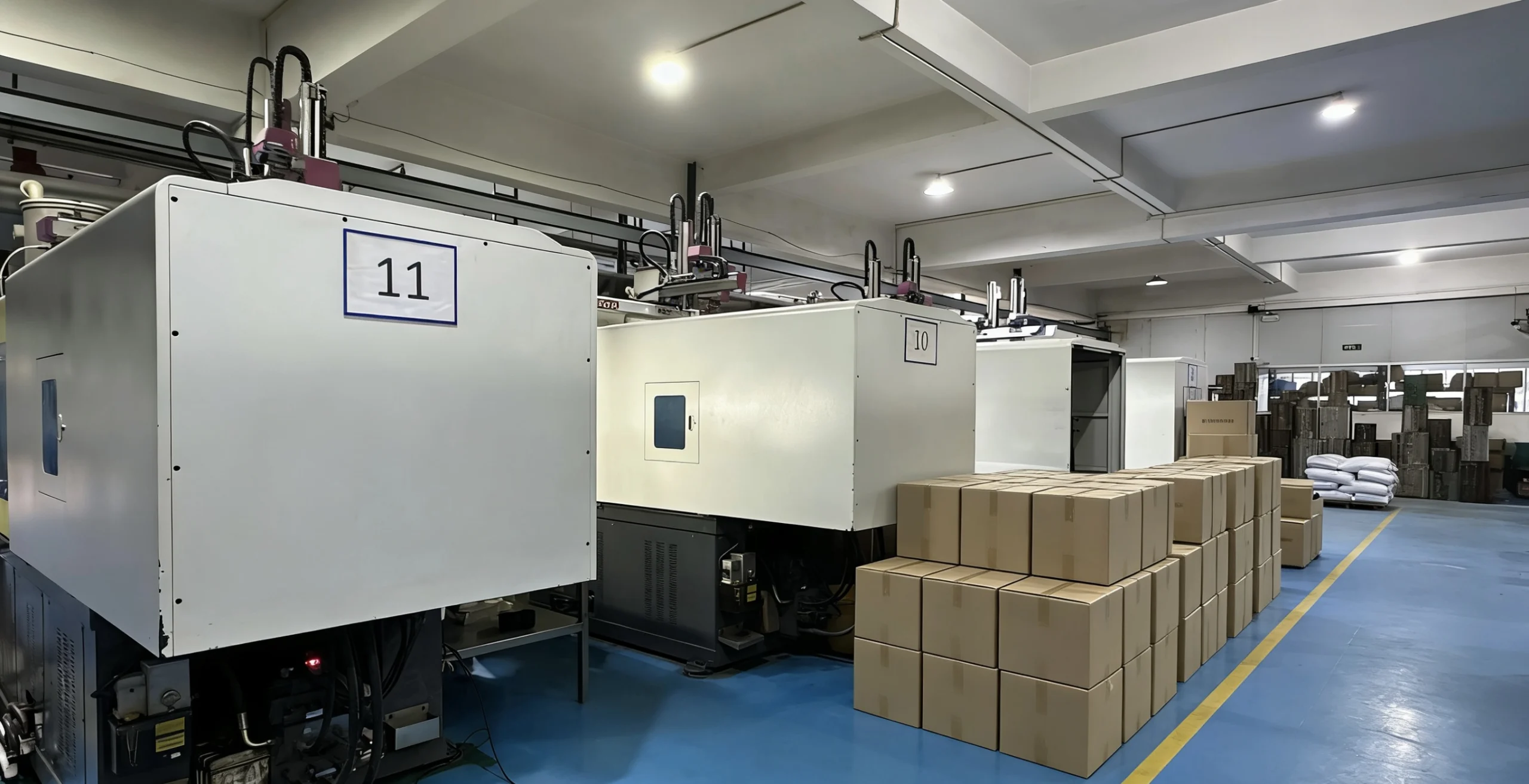 Injection molding factory production line with multiple machines and finished plastic parts ready for shipment
