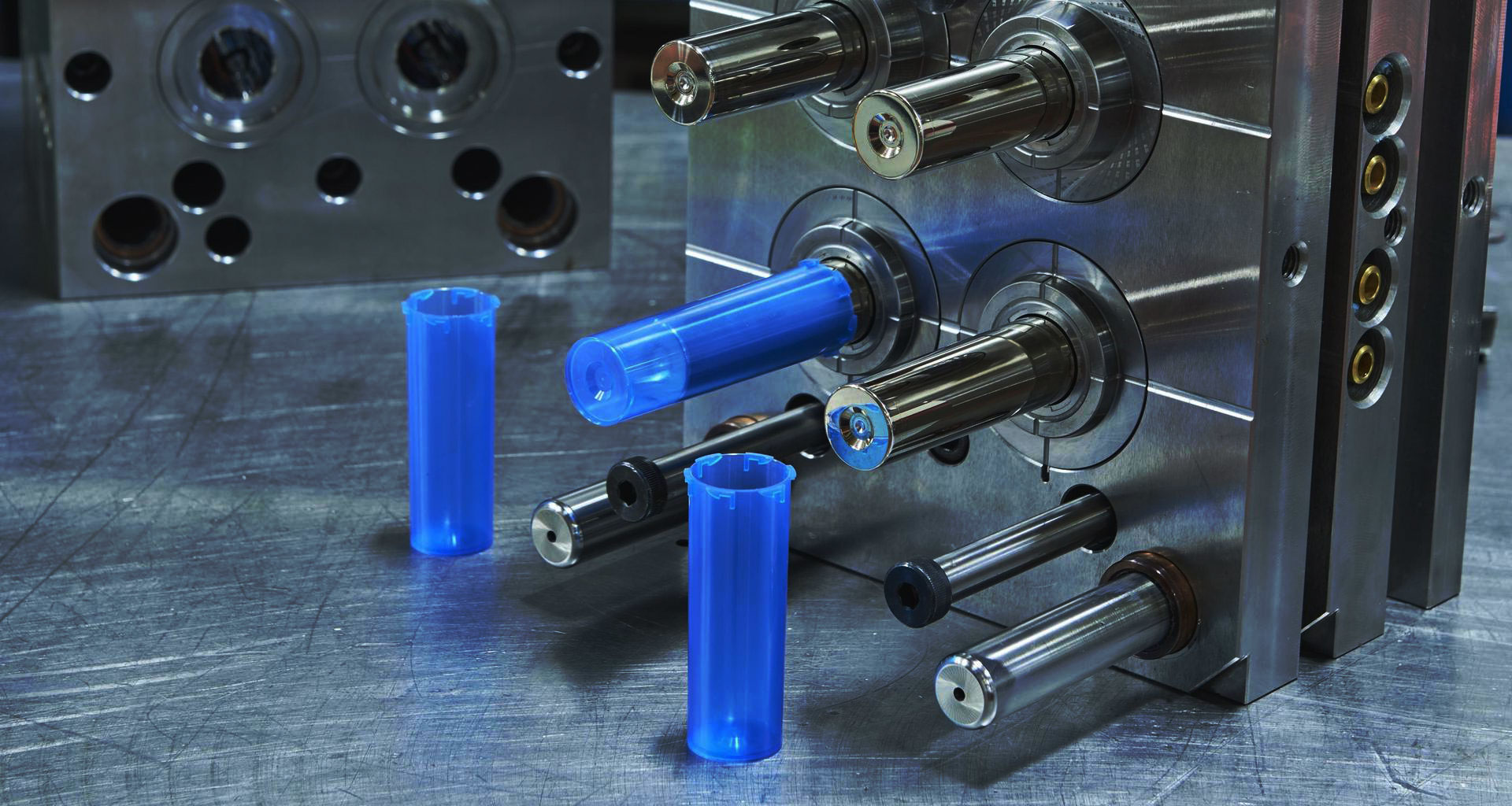 Multi-cavity injection mold in operation producing plastic parts during injection molding process