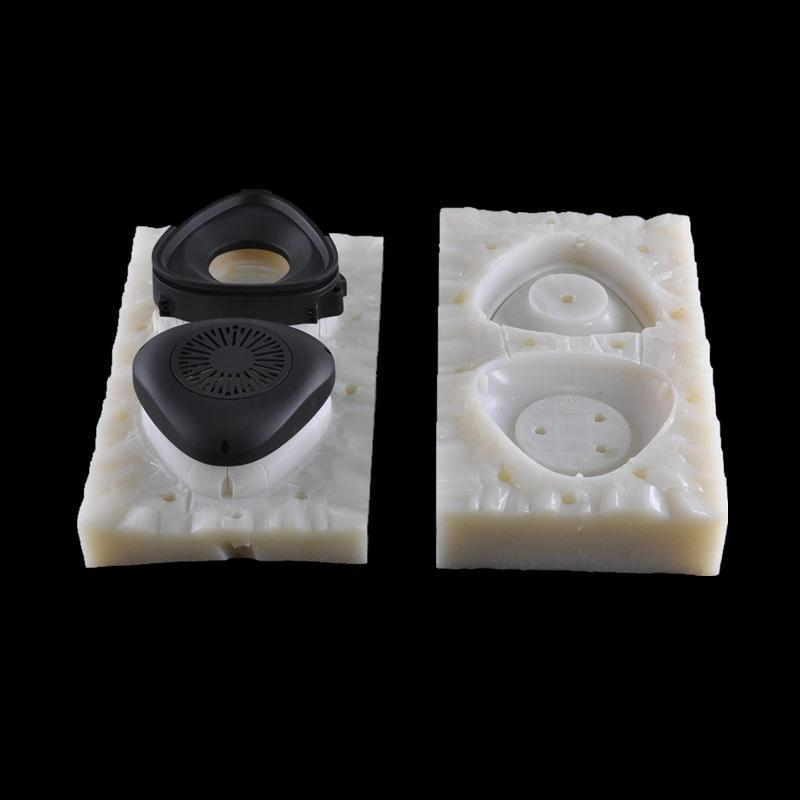 Vacuum casting demolding process removing black plastic prototype from silicone mold