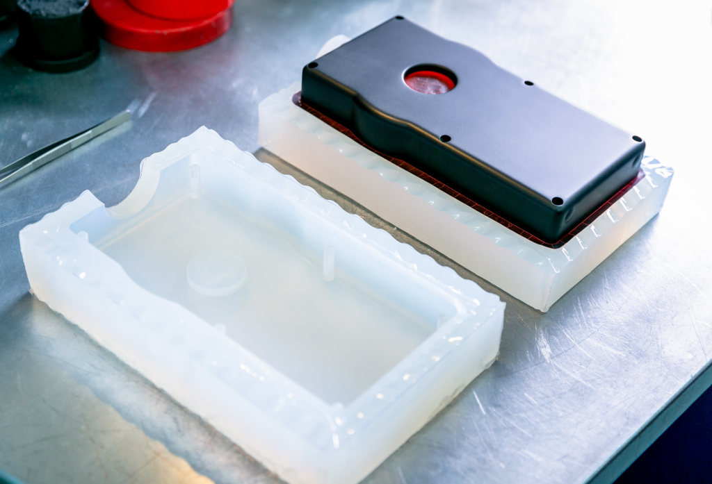 Vacuum casting using silicone mold to create precision black plastic housing prototypes