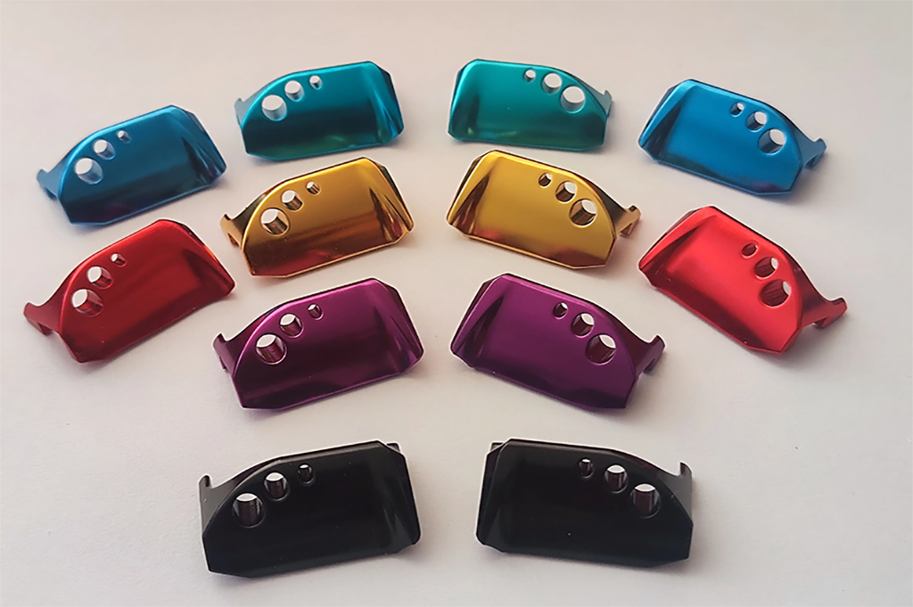 CNC machined aluminum components with multi-color anodizing finishes showing consistent color quality and precision