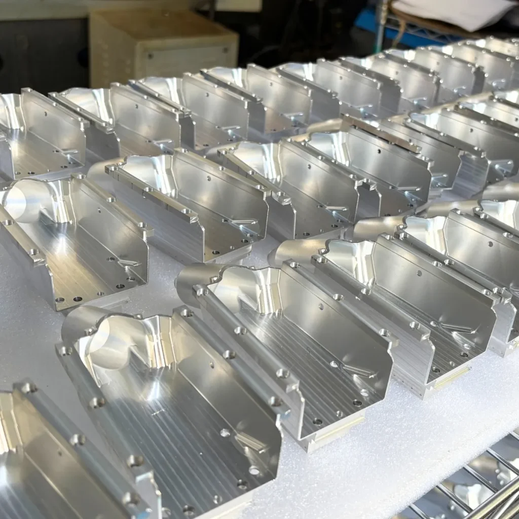 Batch CNC milled aluminum 6061 enclosure bracket housing components with precision bored mounting holes — custom high-volume aluminum machined parts