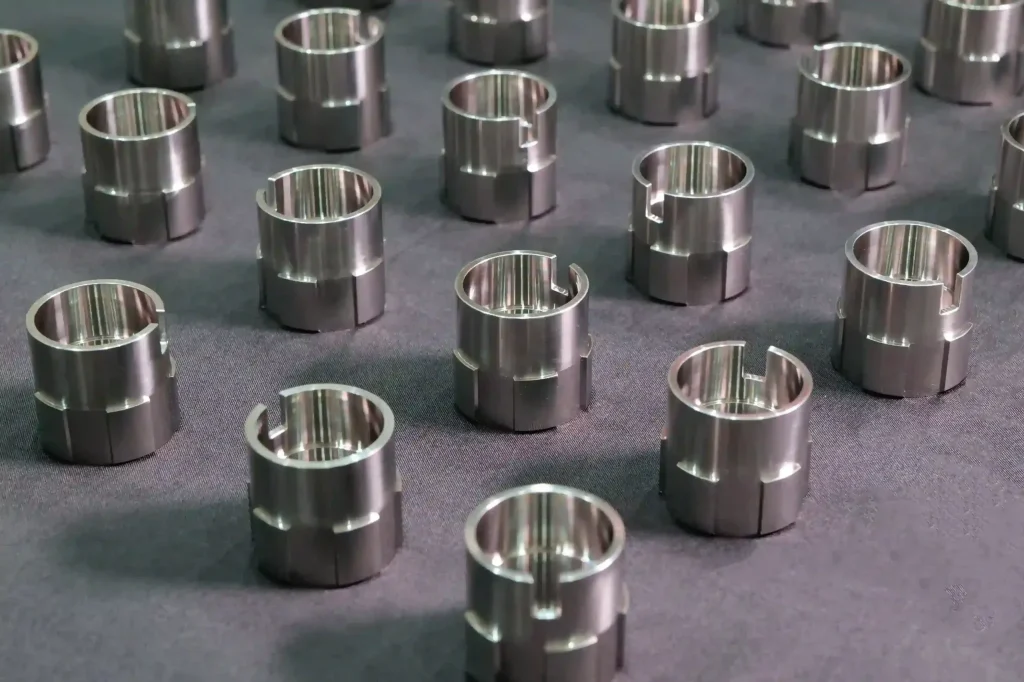Batch CNC turned and milled stainless steel slotted ring sleeve bushings with precision inner bore — custom high-volume turned parts manufacturing