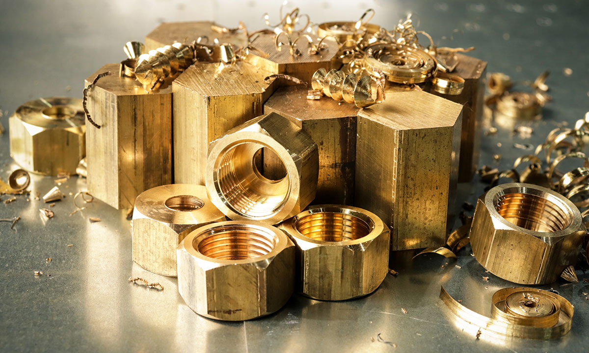 High-volume CNC turned brass hex nuts with internal threads manufactured from brass hex bar stock materials