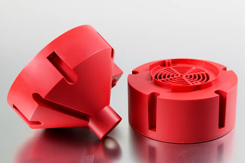 Custom injection molded red ABS plastic fan housing and appliance enclosure cover with ventilation grid — precision plastic mold manufacturing for consumer electronics and home appliance OEM