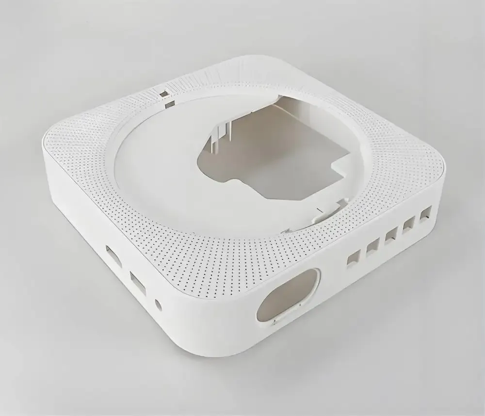 Custom injection molded white ABS plastic smart speaker or WiFi router housing with precision perforated ventilation pattern — consumer electronics enclosure mold manufacturing for IoT smart home devices