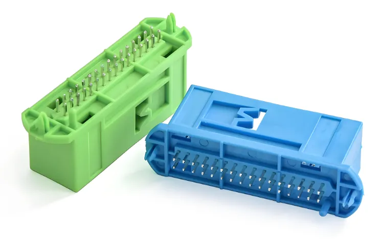 Insert molding multi-pin automotive wire harness connector in green and blue PA PBT engineering plastic with stainless steel pin terminals and latch lock structure, precision plastic insert molding parts for automotive ECU BCM wire harness plug socket connector manufacturing service