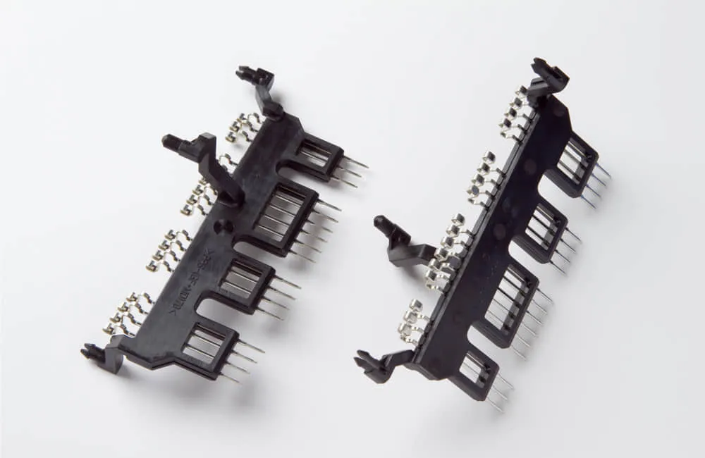 Insert molding PCB multi-group spring contact stamped blade terminal array with black engineering plastic base and through-hole pins, precision electrical insert molding module parts for relay socket signal transmission and PCB board connector insert molding manufacturing service