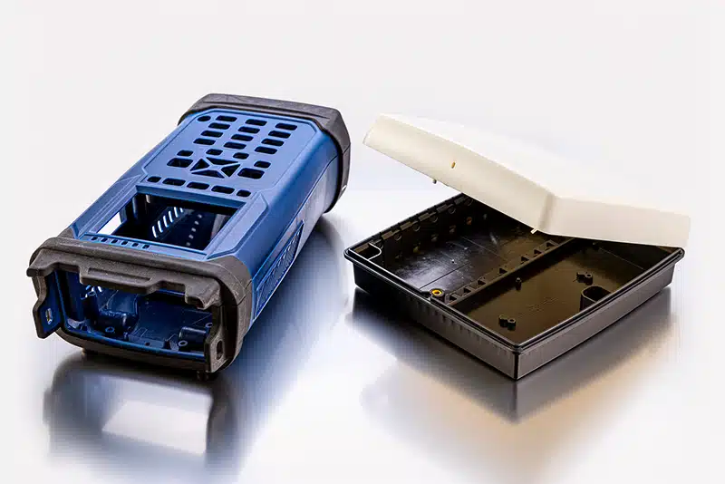 Two-shot injection molded rugged handheld barcode scanner enclosure with overmolded rubber bumper and vented housing — custom consumer electronics instrument enclosure mold manufacturing