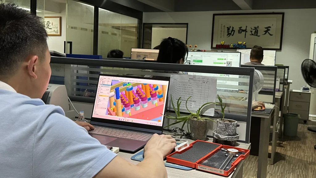 Professional CNC machining and injection mold engineering team performing 3D CAD design review, manufacturability analysis (DFM), and precision mold development validation for custom metal and plastic parts manufacturing.