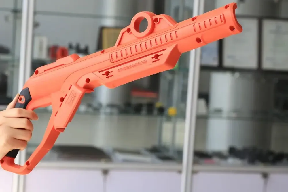 Custom consumer product housing manufactured using precision overmolding services with ABS substrate and TPE soft-touch grip, showcasing advanced multi-material injection molding capabilities.