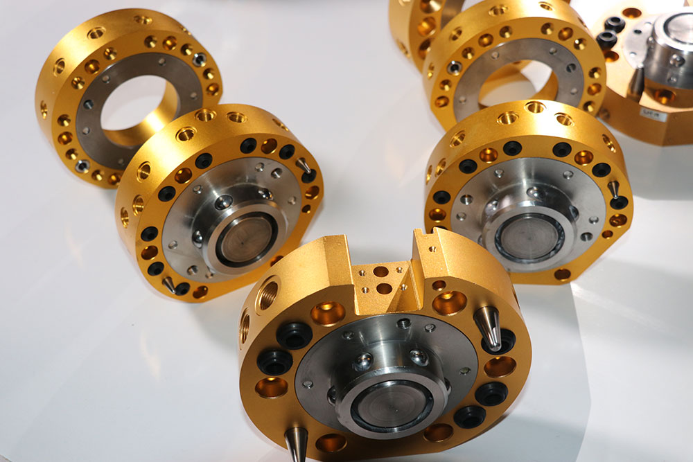Custom CNC milling gold anodized aluminum precision flange and rotary joint components with multi-hole pattern — tight-tolerance 5-axis machined parts for industrial automation and aerospace applications